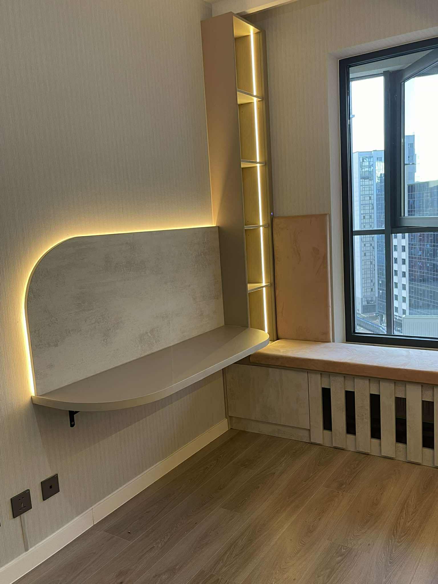 Study nook with concrete-effect shelving and LED strip