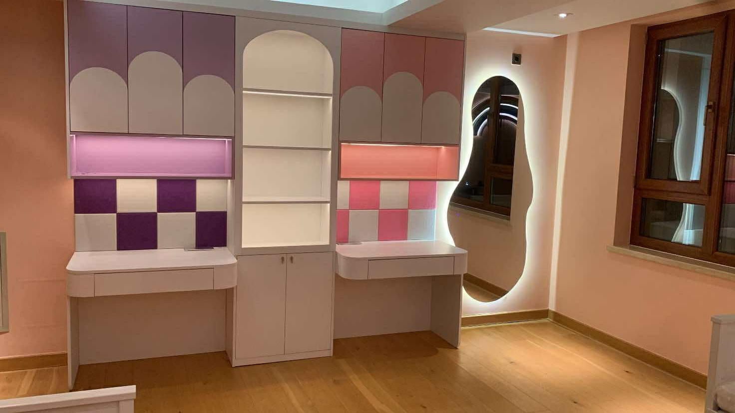Dual children's study with playful pink cabinetry
