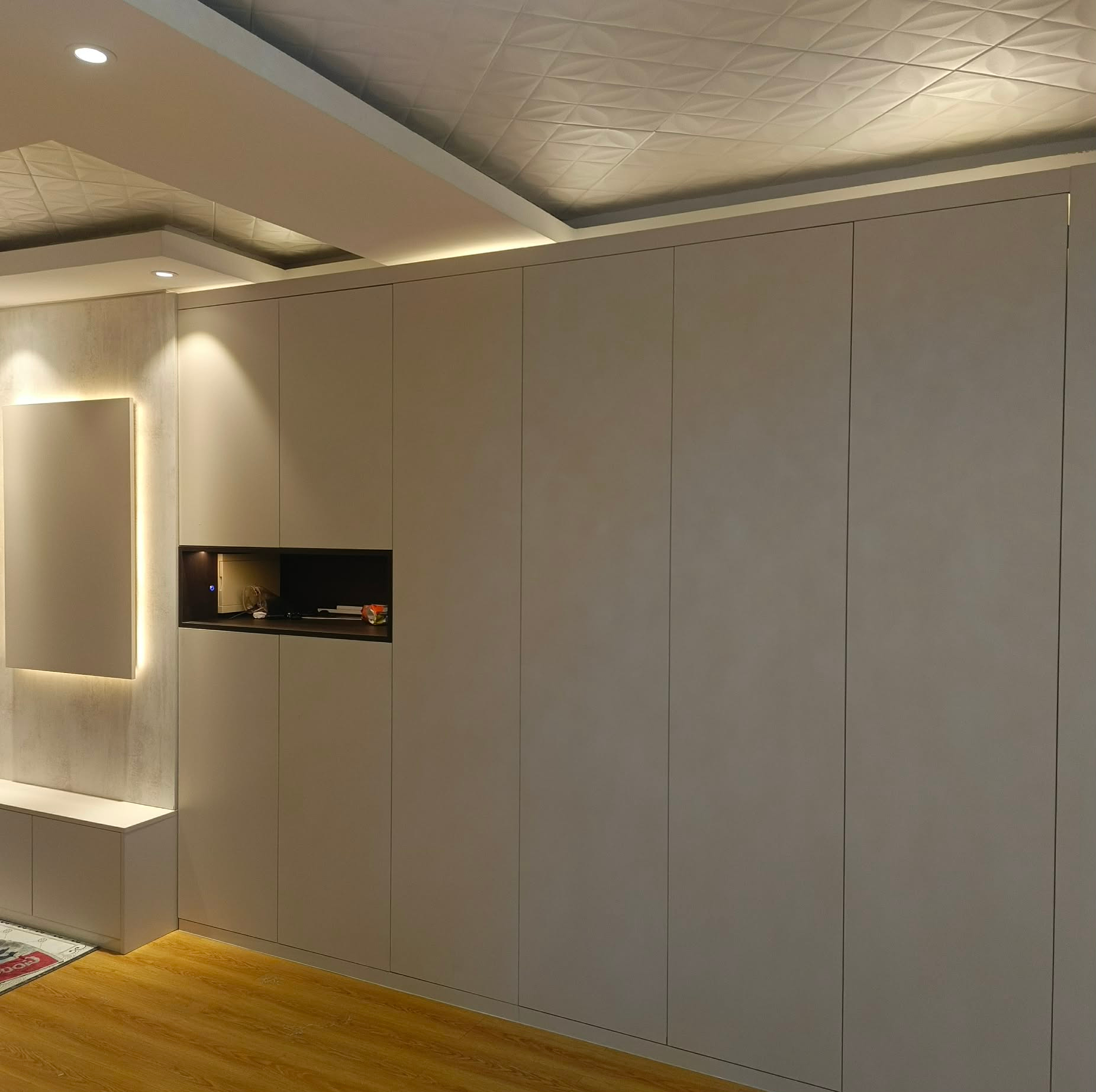 Full-height wardrobe wall with decorative ceiling panel