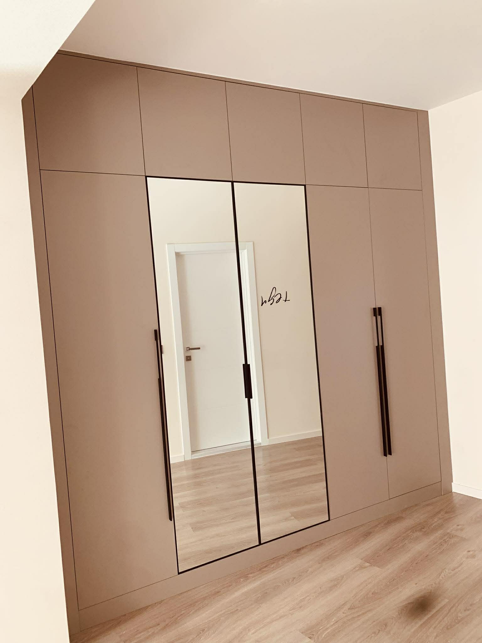 Taupe wardrobe with mirrored centre panels
