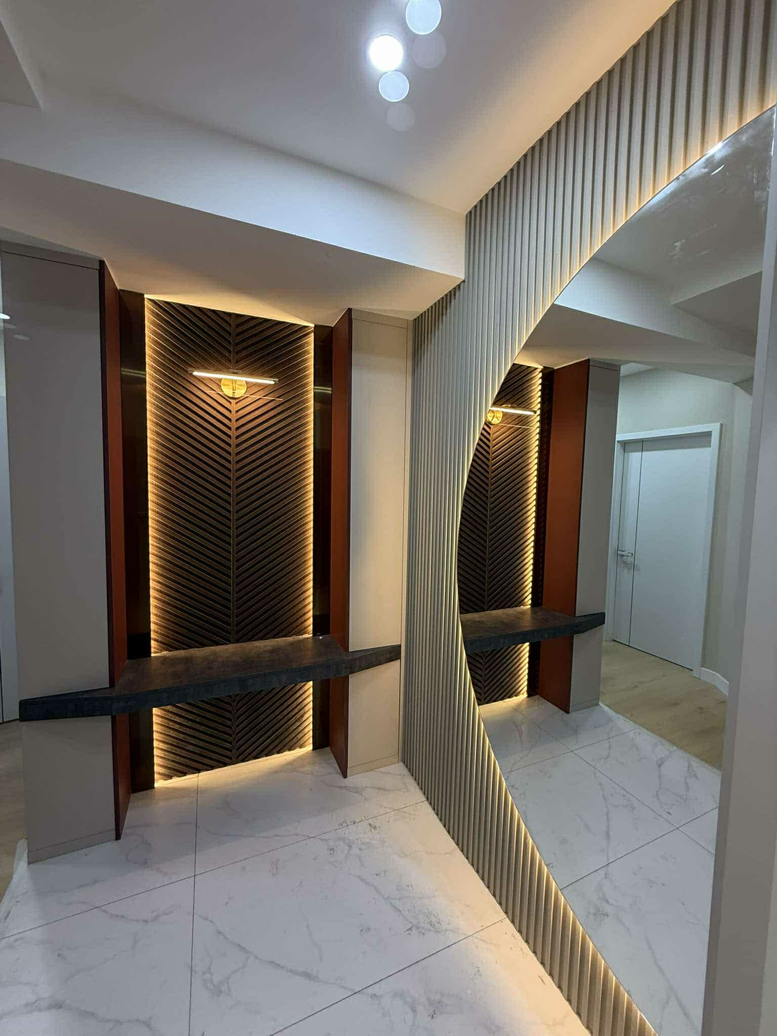 Entryway with gold diagonal panel feature and marble floor