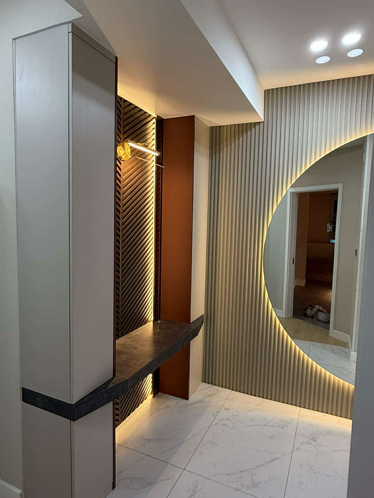 Corridor with round backlit mirror and terracotta panel