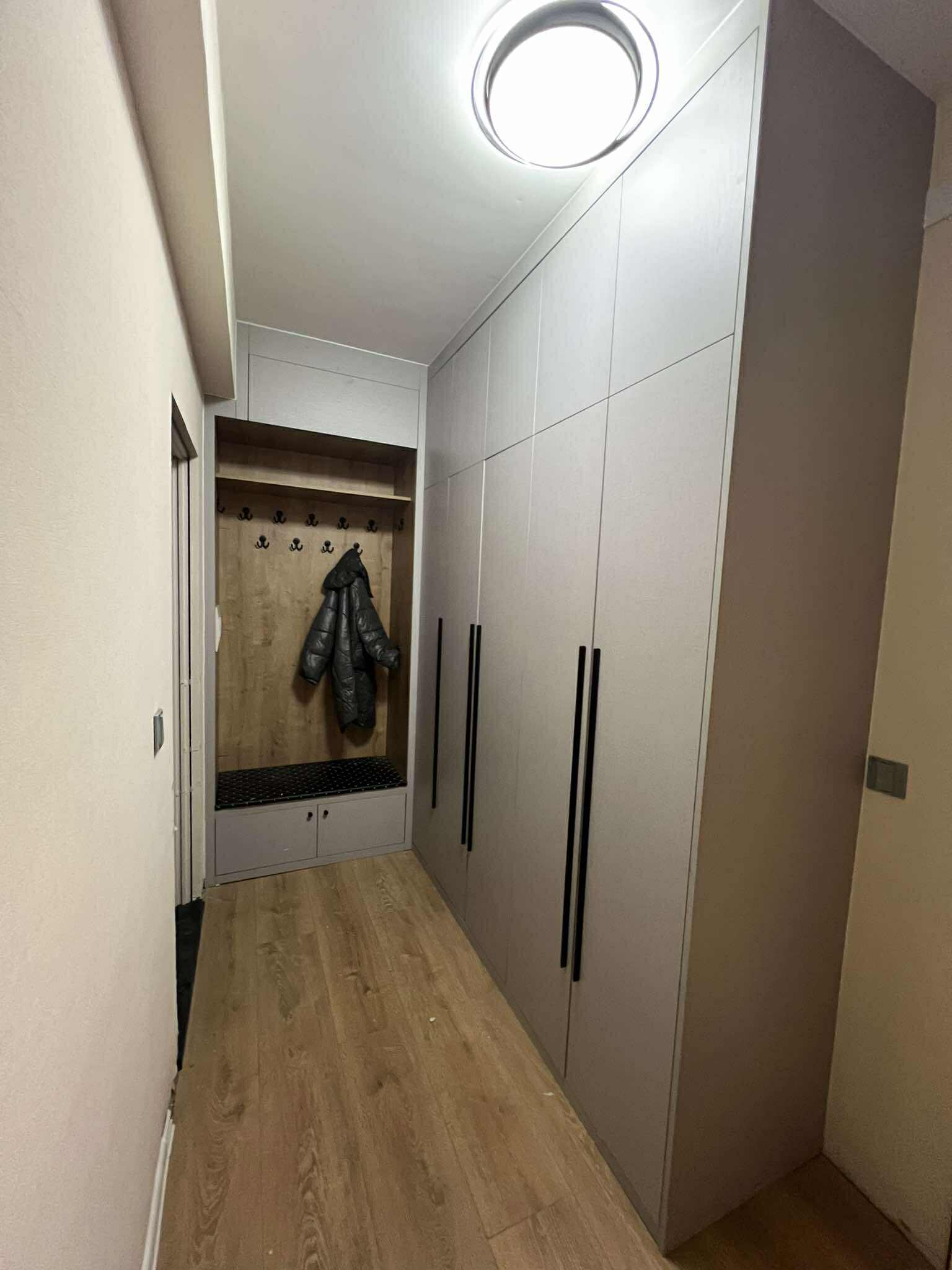 Grey wardrobe with coat hooks and shoe bench