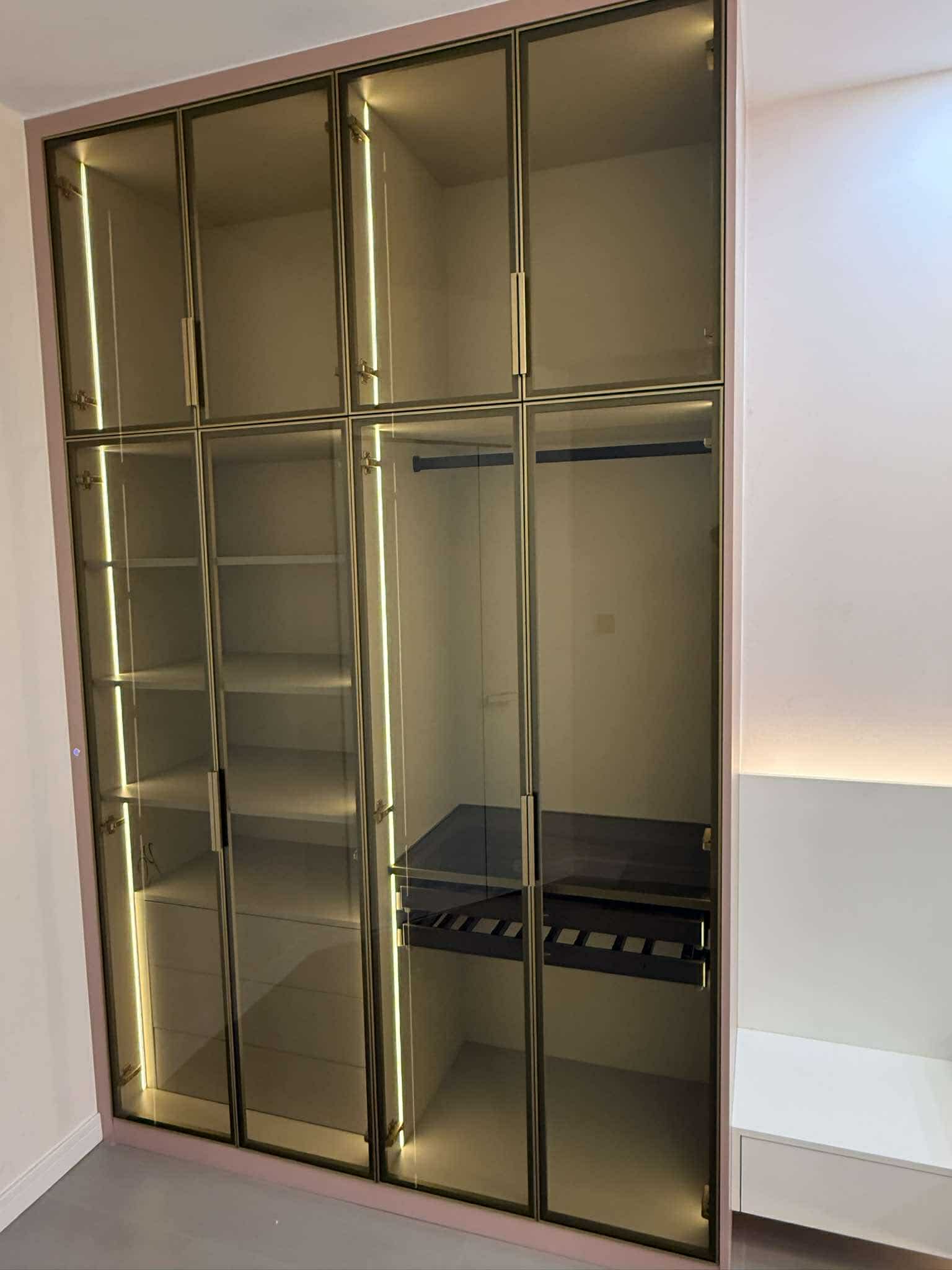 Pink-framed glass wardrobe with lit interior