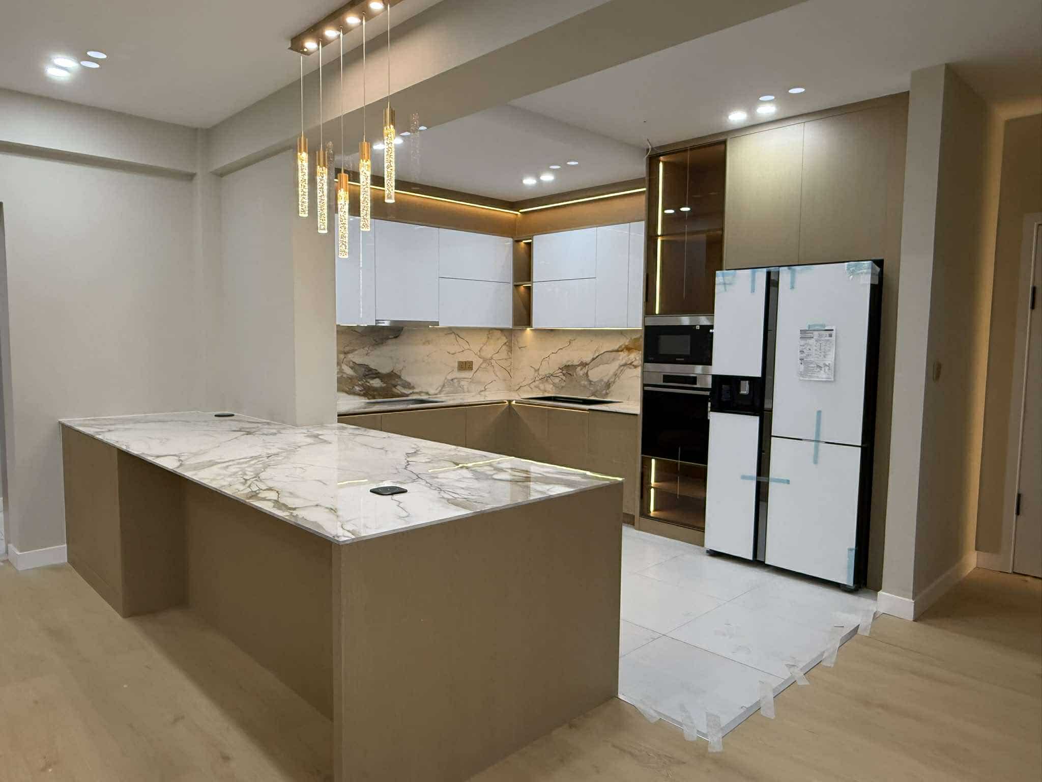 Kitchen with marble island and pendant lighting