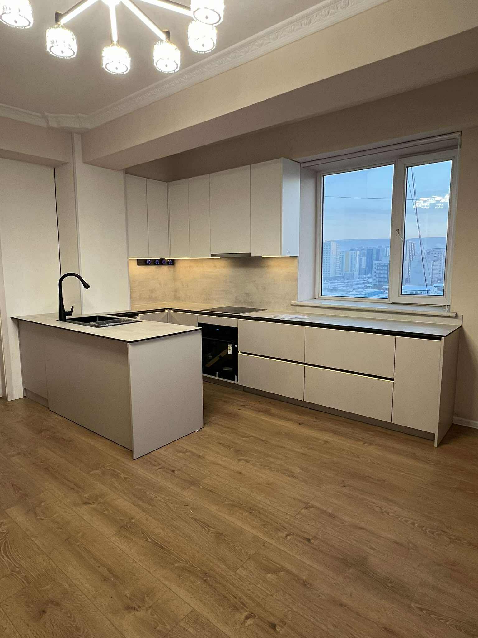 White kitchen with city view and marble countertop