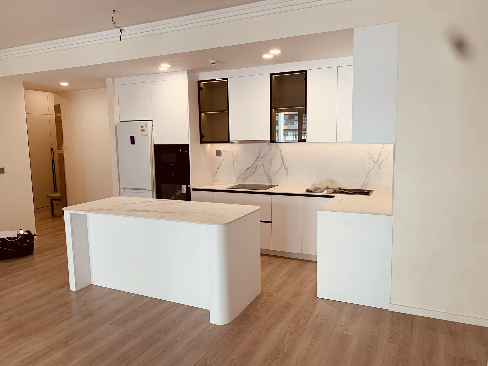 White kitchen with marble backsplash and island