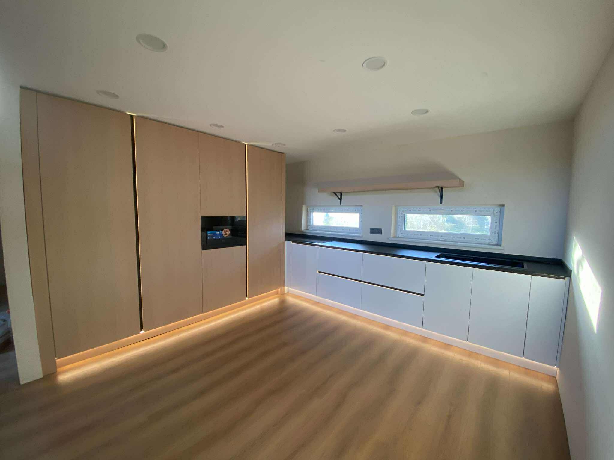 Curved kitchen with marble island and warm glow