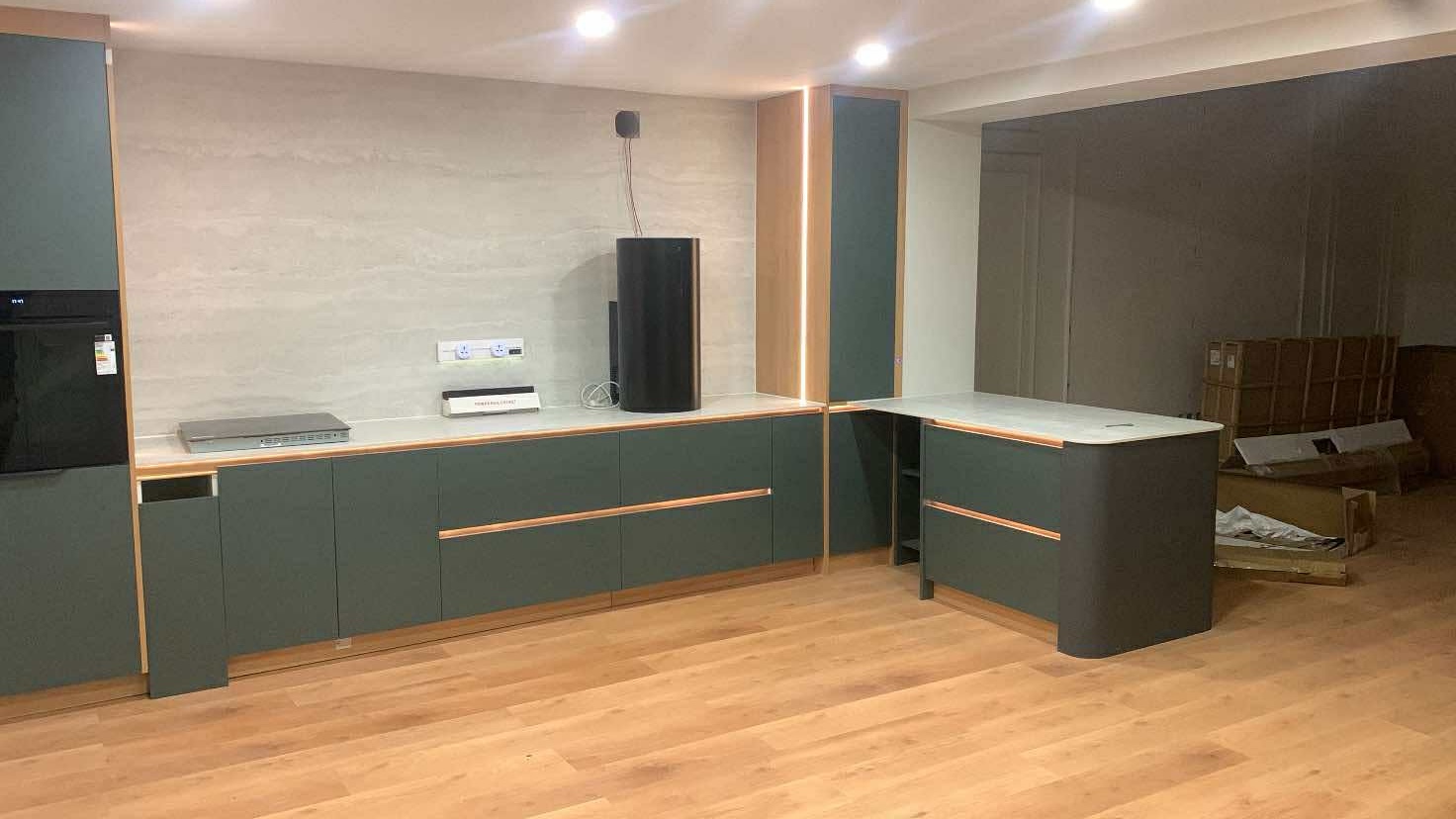 Forest green kitchen with copper handles