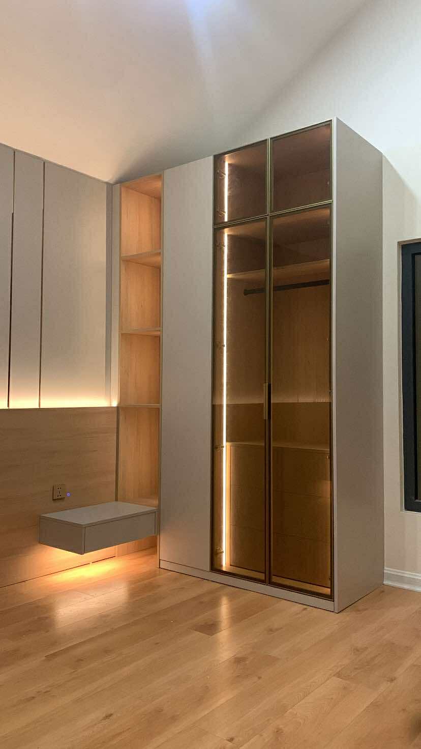 Glass display wardrobe with warm interior lighting
