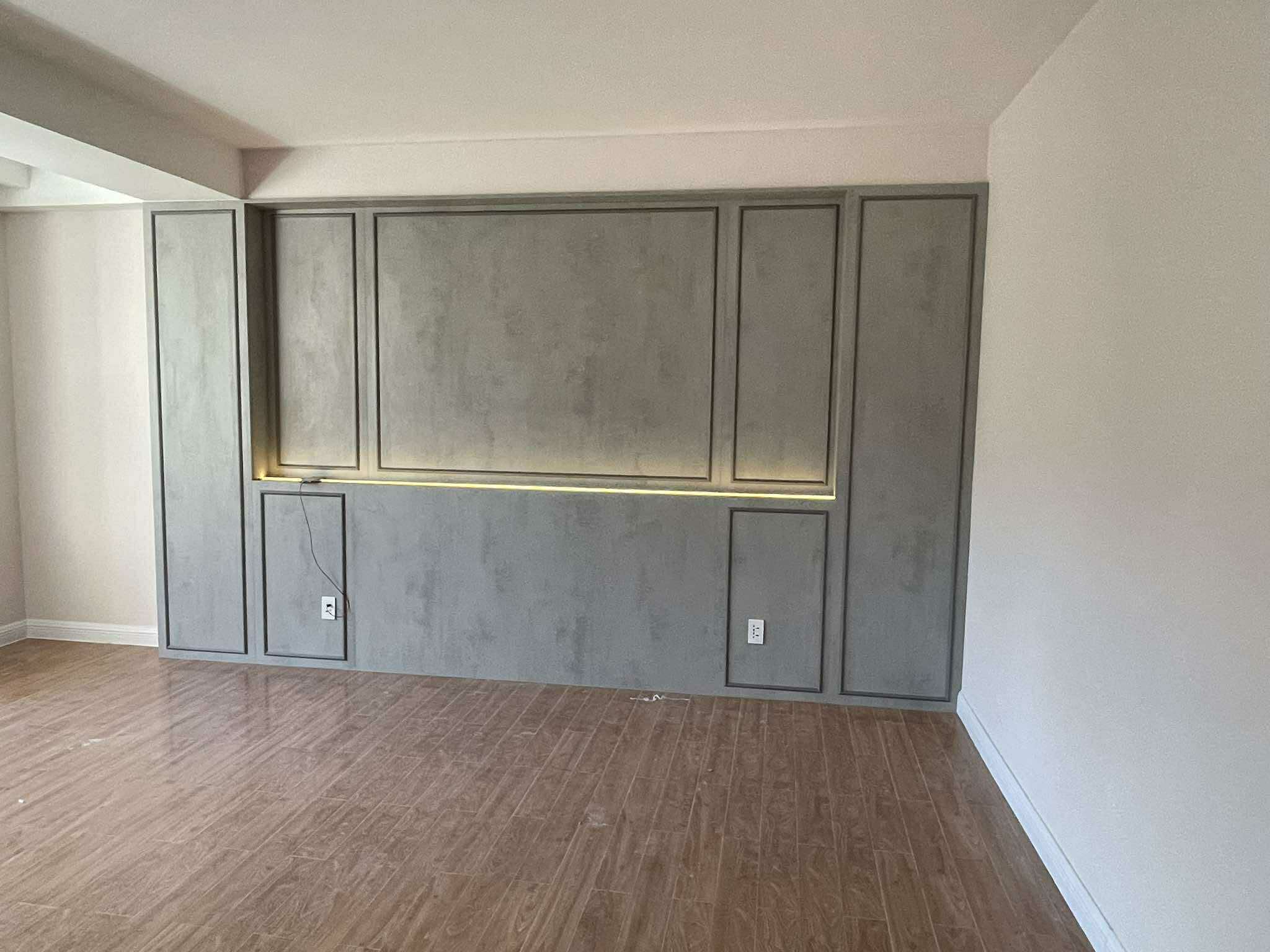 Minimalist TV feature wall in concrete grey