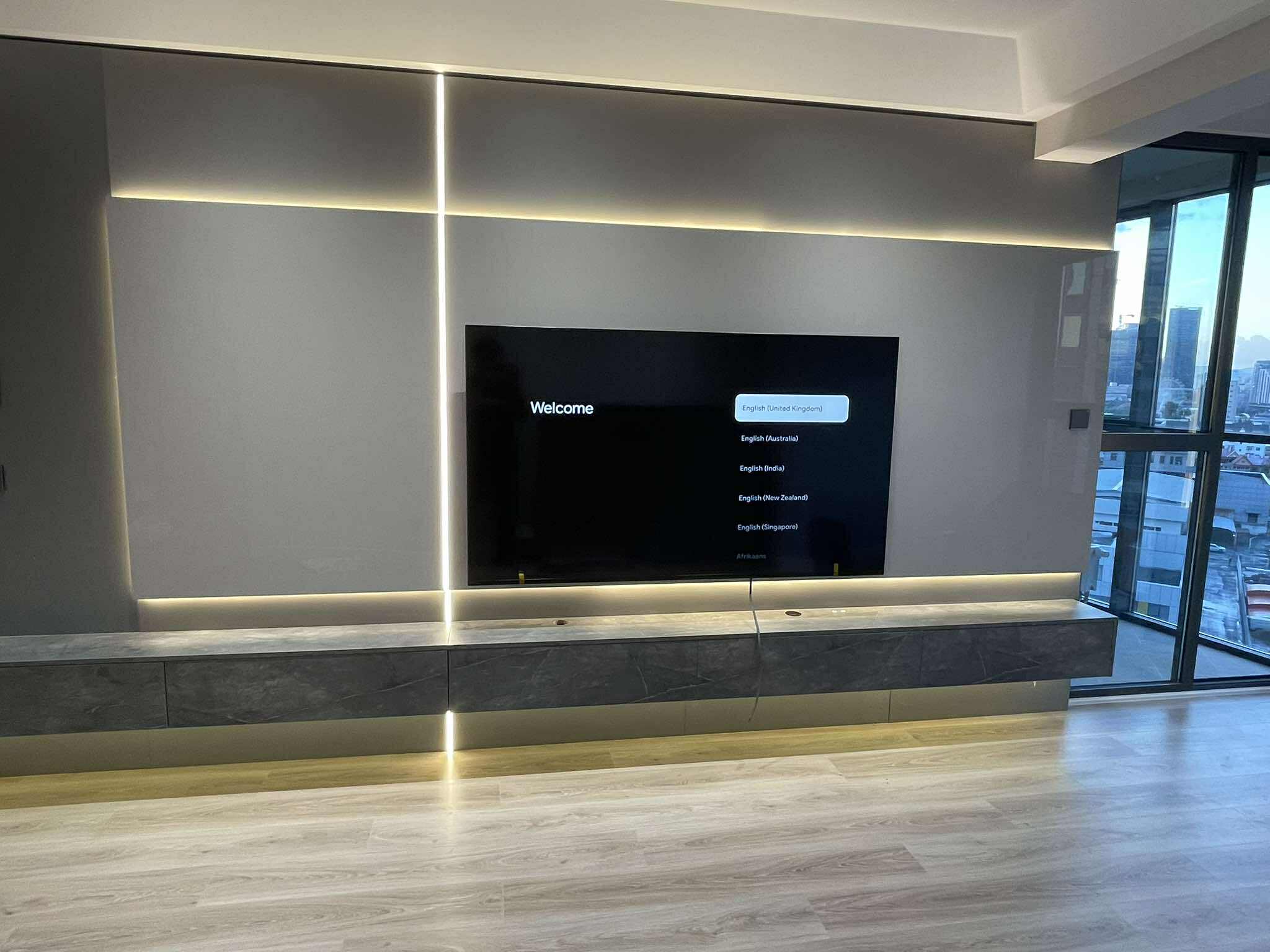 TV wall unit with marble surround and chandelier