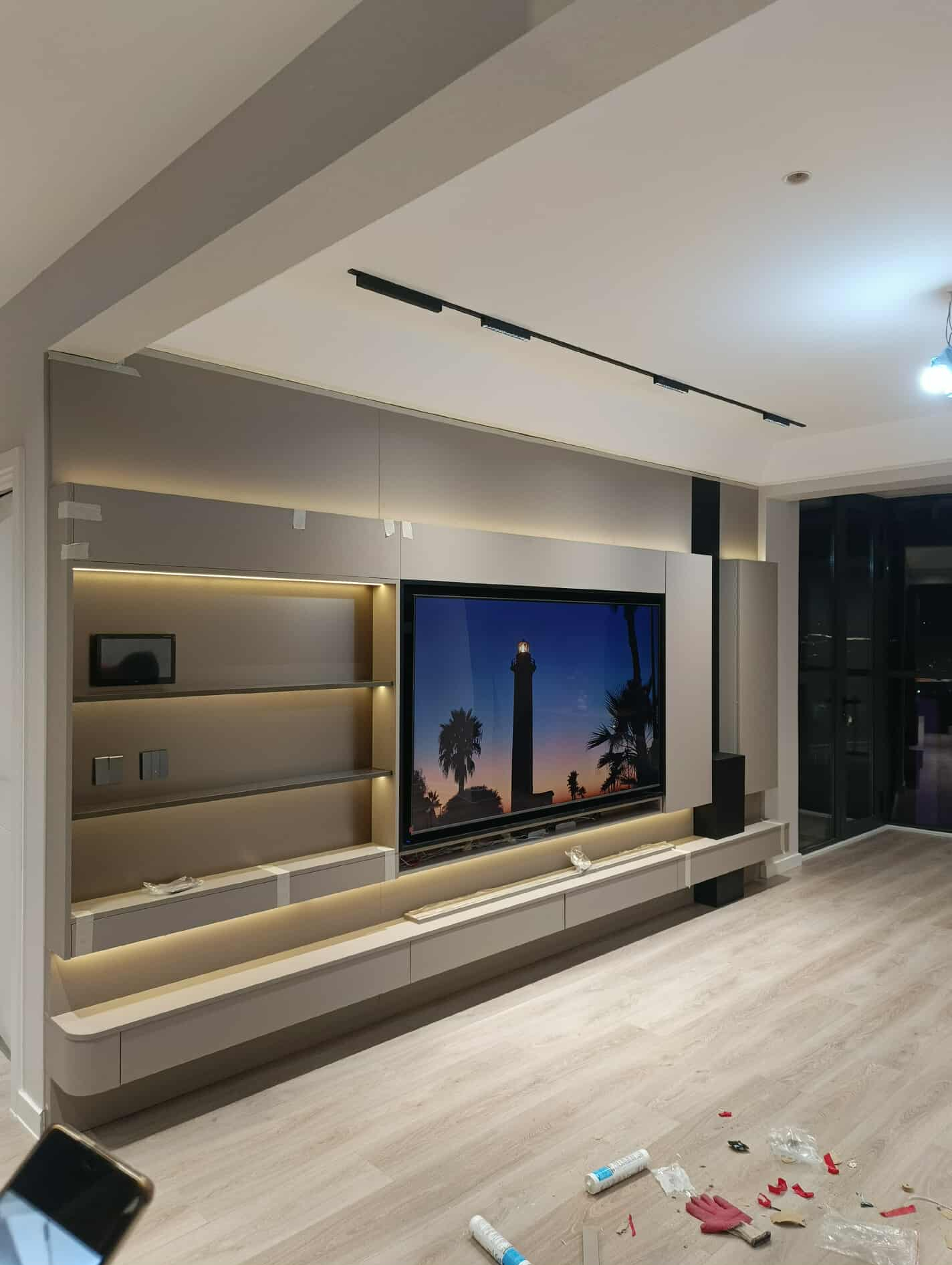 Entertainment wall with floating shelves and LED lighting